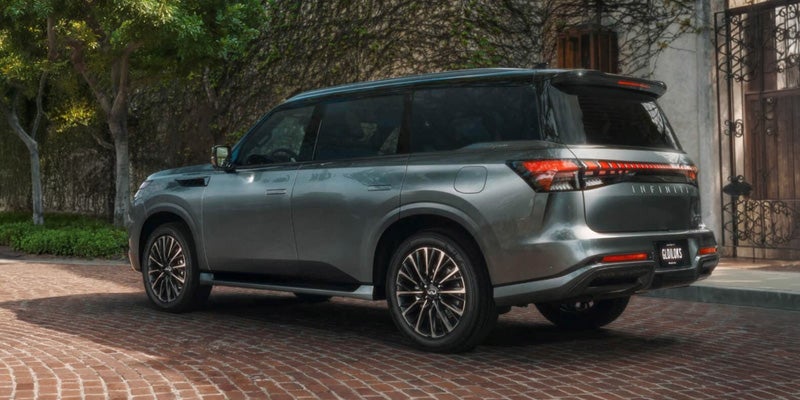 Gray 2027 INFINITI QX65 SUV rear side view.