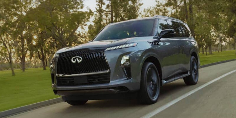Gray 2027 INFINITI QX65 SUV driving on road.