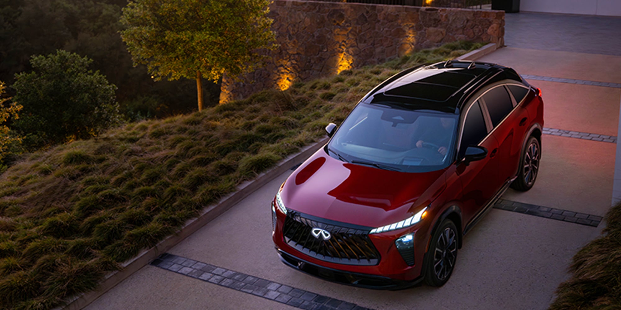Red 2027 INFINITI QX65 SUV parked outdoors.