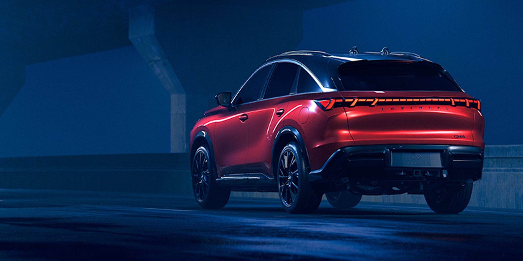 Red 2027 INFINITI QX65 SUV rear view at night.